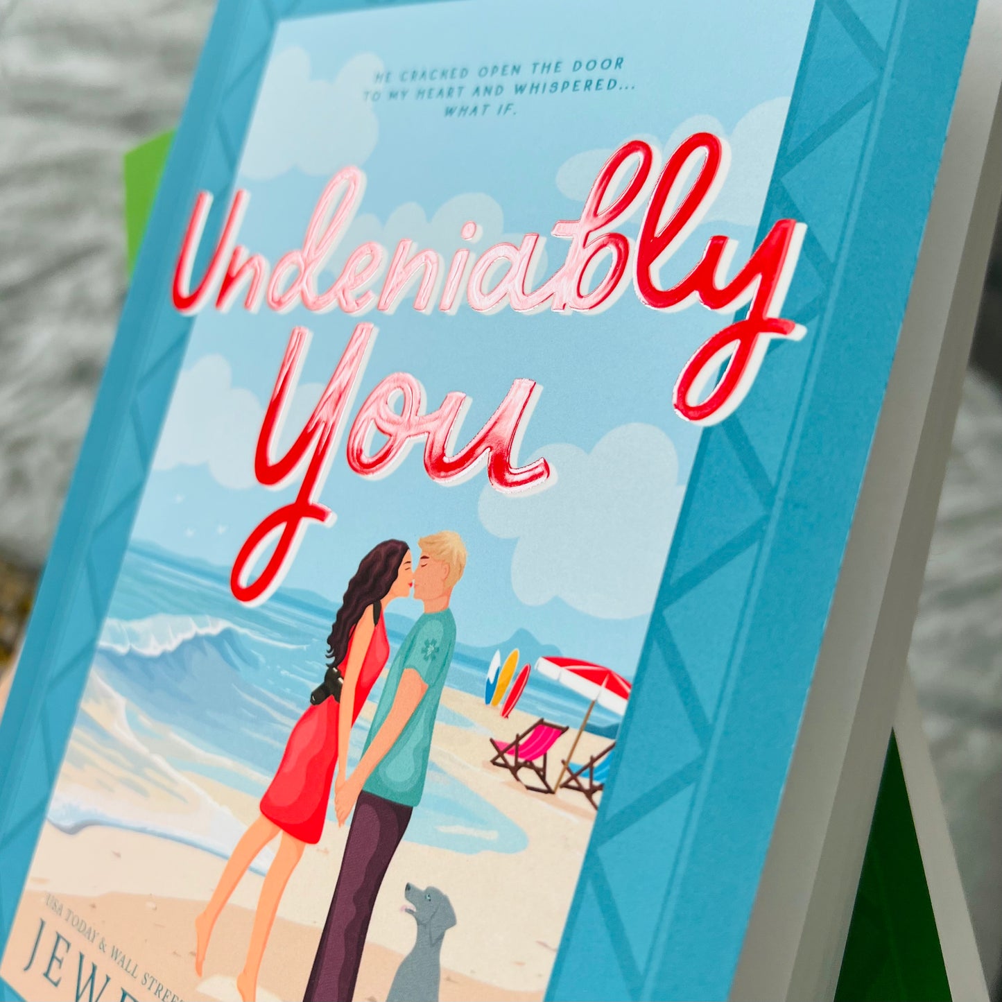 Close up photo of the diamond 3d clear coat on the title of the illustrated paperback of Undeniably You by Jewel E. Ann